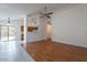 Spacious living room with hardwood floors that leads to the dining area and kitchen at 10647 N 63Rd Dr, Glendale, AZ 85304