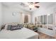 Bedroom with natural light, a patterned chair, throw pillows, and mirrored closet doors at 11226 W Glenrosa Ave, Phoenix, AZ 85037