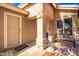 Inviting front entrance with a security door, textured walls, and a cozy bench for relaxation at 11226 W Glenrosa Ave, Phoenix, AZ 85037