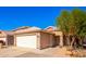 Inviting home exterior with a two-car garage, well-maintained landscaping, and a welcoming front entrance at 11226 W Glenrosa Ave, Phoenix, AZ 85037