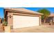 Spacious two-car garage featuring a clean, neutral door, well-maintained exterior, and desert landscaping at 11226 W Glenrosa Ave, Phoenix, AZ 85037