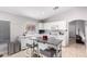 Bright kitchen with central island, white cabinets, and white appliances at 11226 W Glenrosa Ave, Phoenix, AZ 85037