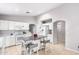 Bright kitchen with central island, white cabinets, and white appliances at 11226 W Glenrosa Ave, Phoenix, AZ 85037