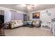 Living room with wood look tile, ceiling fan, comfortable seating, and neutral decor at 11226 W Glenrosa Ave, Phoenix, AZ 85037