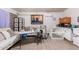 Living room with wood look tile, ceiling fan, comfortable seating, and neutral decor at 11226 W Glenrosa Ave, Phoenix, AZ 85037