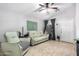 Bright living room with tile flooring, ceiling fan, sofa, and a door leading to another area of the house at 11226 W Glenrosa Ave, Phoenix, AZ 85037