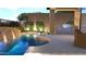 Inviting pool with water feature, outdoor kitchen, and lush landscaping at 12326 E Black Rock Rd, Scottsdale, AZ 85255