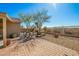 Brick-paved patio area with dining set, surrounded by desert landscaping, providing a relaxing outdoor experience at 1268 S 238Th Ln, Buckeye, AZ 85326