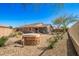 Desert-style backyard with a hot tub, covered patio, and a mix of gravel and greenery for low-maintenance living at 1268 S 238Th Ln, Buckeye, AZ 85326