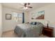 Inviting bedroom featuring neutral tones, ceiling fan, bedside table, and natural light at 1268 S 238Th Ln, Buckeye, AZ 85326