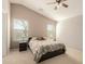 Cozy bedroom with a ceiling fan, carpet, and bedside tables at 1268 S 238Th Ln, Buckeye, AZ 85326