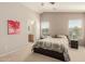 Neutral bedroom with ensuite bathroom featuring carpet, ceiling fan, and natural light at 1268 S 238Th Ln, Buckeye, AZ 85326