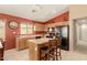 Kitchen with a center island, black appliances, tile floors, and warm-toned walls at 1268 S 238Th Ln, Buckeye, AZ 85326