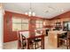 View of the kitchen with a dining table, oak cabinets, and stainless steel appliances at 1268 S 238Th Ln, Buckeye, AZ 85326