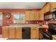 Kitchen featuring stainless steel appliances, oak cabinets, and a double basin sink overlooking the backyard at 1268 S 238Th Ln, Buckeye, AZ 85326