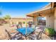 Enjoy the outdoor living space featuring a covered patio, dining table, and barbecue grill for entertainment at 1268 S 238Th Ln, Buckeye, AZ 85326