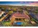 Expansive aerial view of a single-Gathering home featuring a private pool, lush landscaping, and a red tile roof at 1708 W Gambit Trl, Phoenix, AZ 85085