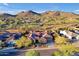 Beautiful aerial view of a desert home near mountains, showcasing solar panels and desert landscaping at 1708 W Gambit Trl, Phoenix, AZ 85085