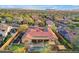 Beautiful aerial view of a desert home with a pool, lush landscaping, solar panels, and a red tile roof at 1708 W Gambit Trl, Phoenix, AZ 85085