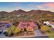 Stunning aerial view of the home showcasing the tiled roof and mountain views in the distance at 1708 W Gambit Trl, Phoenix, AZ 85085