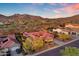 Gorgeous aerial view of the home with a tiled roof and mountain views, showcasing the surrounding neighborhood at 1708 W Gambit Trl, Phoenix, AZ 85085