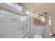 This bathroom features subway tile with a decorative accent border and glass shower door at 1708 W Gambit Trl, Phoenix, AZ 85085