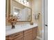 This bathroom vanity offers a large mirror, traditional cabinets, and decorative flowers at 1708 W Gambit Trl, Phoenix, AZ 85085