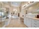 This luxury bathroom features tile floors, dual sinks, soaking tub and exquisite lighting at 1708 W Gambit Trl, Phoenix, AZ 85085