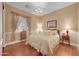 This cozy bedroom features hardwood floors, natural lighting, and decorative accents at 1708 W Gambit Trl, Phoenix, AZ 85085