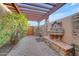 Charming courtyard featuring stone accents, a pergola, and water fountain with beautiful vegetation all around at 1708 W Gambit Trl, Phoenix, AZ 85085