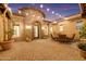 Inviting courtyard featuring a stone accent wall, cozy seating area, and elegant lighting, perfect for outdoor enjoyment at 1708 W Gambit Trl, Phoenix, AZ 85085