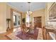 Bright dining room featuring a wooden table, chandelier, hardwood floors, and view of patio at 1708 W Gambit Trl, Phoenix, AZ 85085