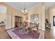 Dining room featuring a wooden table, chandelier, hardwood floors, and view of entry at 1708 W Gambit Trl, Phoenix, AZ 85085