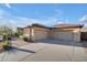 Charming exterior features a three-car garage, mature desert landscaping, a tiled roof, and block construction at 1708 W Gambit Trl, Phoenix, AZ 85085