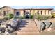 Charming exterior featuring stone accents, desert landscaping, and a brick staircase leading up to the front door at 1708 W Gambit Trl, Phoenix, AZ 85085