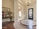 Elegant foyer featuring a decorative chandelier, hardwood floors, and a stylish entrance door at 1708 W Gambit Trl, Phoenix, AZ 85085