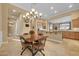 Bright eat-in kitchen featuring tile floors, open layout, and wooden cabinets at 1708 W Gambit Trl, Phoenix, AZ 85085