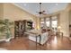 Comfortable living room with a ceiling fan, hardwood flooring, natural light, and display cabinet at 1708 W Gambit Trl, Phoenix, AZ 85085