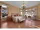 Serene main bedroom featuring hardwood floors, a chandelier, and plenty of natural light at 1708 W Gambit Trl, Phoenix, AZ 85085