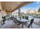 An expansive covered patio features an outdoor dining area and views of the pool at 1708 W Gambit Trl, Phoenix, AZ 85085