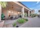 A covered patio with ceiling fans provides shade and comfort, with desert plants and tiled flooring at 1708 W Gambit Trl, Phoenix, AZ 85085