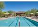 Lap swimming pool featuring lane dividers, sun umbrellas and lounge chairs with mountain views in the background at 1708 W Gambit Trl, Phoenix, AZ 85085