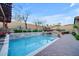 A backyard pool offers a relaxing retreat with a stone waterfall feature and privacy landscaping at 1708 W Gambit Trl, Phoenix, AZ 85085