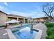 A beautiful backyard pool and spa with an outdoor kitchen, dining area, and lush landscaping at 1708 W Gambit Trl, Phoenix, AZ 85085