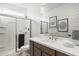 Bright bathroom featuring a glass-enclosed shower, modern vanity, and decorative accents at 17725 W Onyx Ave, Waddell, AZ 85355