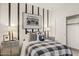 Stylish bedroom featuring a boombox print, industrial nightstands, and a black and white theme at 17725 W Onyx Ave, Waddell, AZ 85355