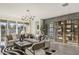 Living room with modern lighting, patterned rug, textured wall, and sliding glass doors at 17725 W Onyx Ave, Waddell, AZ 85355