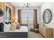 Bright bedroom featuring a daybed, decorative mirror, and modern dresser at 17801 W Mission Ln, Waddell, AZ 85355