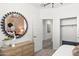 Bedroom featuring stylish decor, including patterned wallpaper, a mirror, and a modern dresser at 17801 W Mission Ln, Waddell, AZ 85355