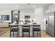 Stylish kitchen with stainless steel appliances, a center island with barstool seating, and modern cabinetry at 17801 W Mission Ln, Waddell, AZ 85355